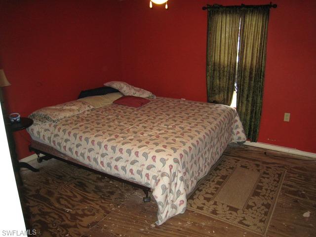 21 Ocho Rios Naples, FL 34114 - Photo 4 of 14 a bed sitting in a bedroom next to a window