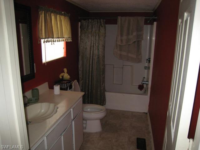 21 Ocho Rios Naples, FL 34114 - Photo 5 of 14 a bathroom with a granite countertop sink toilet and shower