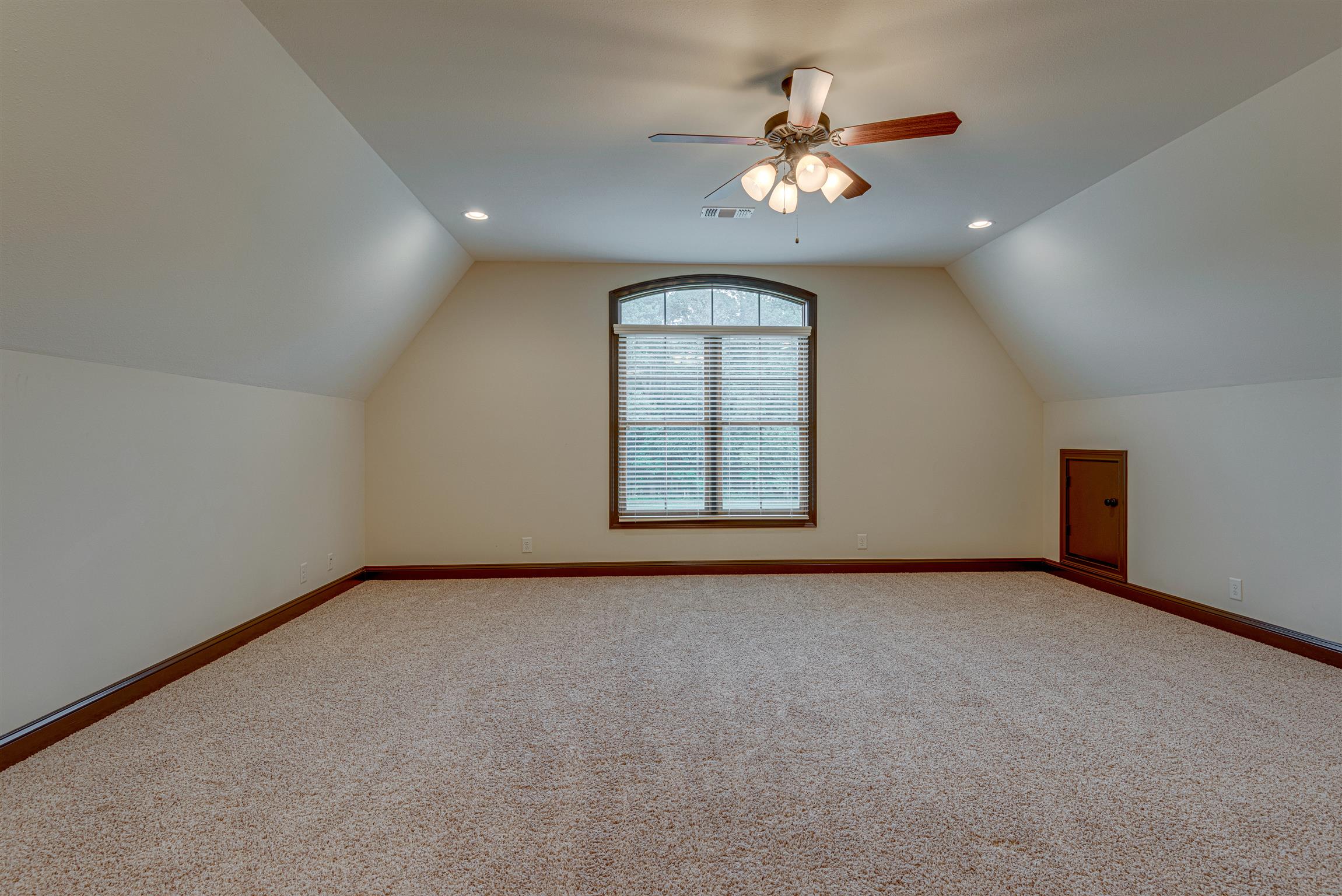 2610 Gunn Road Adams, TN 37010 - Photo 18 of 24 an empty room with a chandelier fan and windows