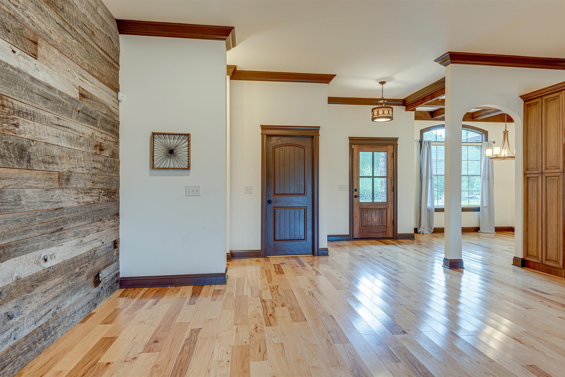 2610 Gunn Road Adams, TN 37010 - Photo 5 of 24 a view of a hallway with wooden floor and a bathroom