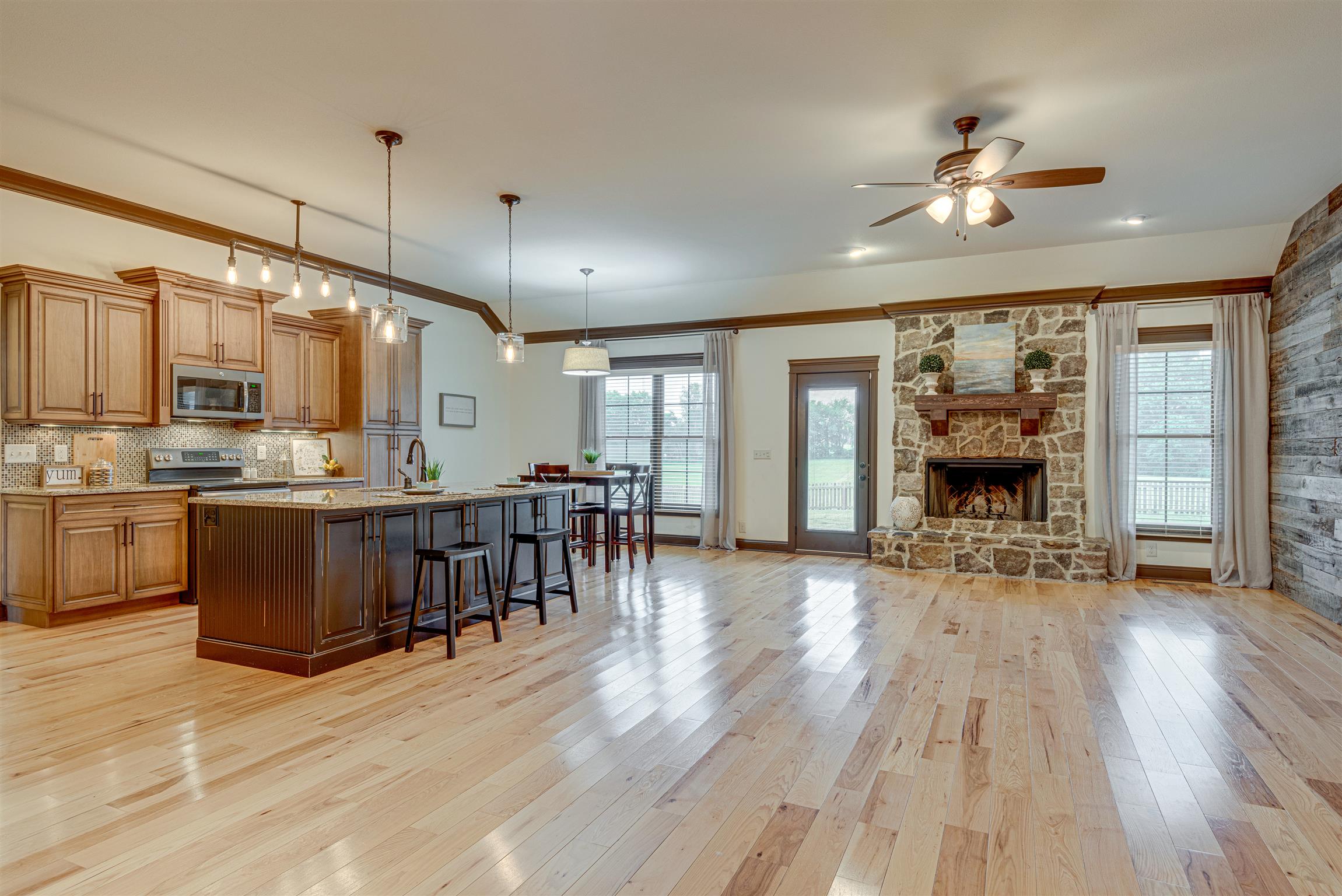 2610 Gunn Road Adams, TN 37010 - Photo 6 of 24 a open kitchen with kitchen island a large island in the center cabinets and wooden floor