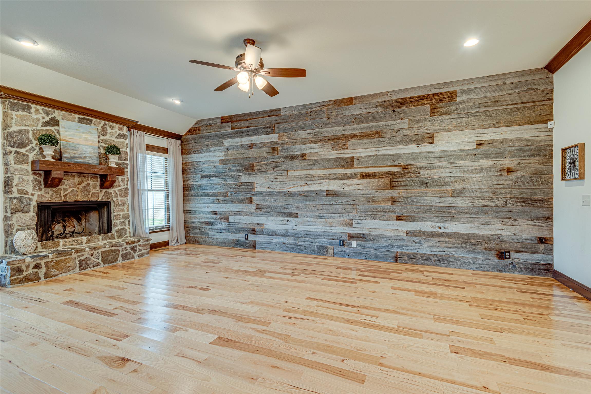 2610 Gunn Road Adams, TN 37010 - Photo 7 of 24 a view of hall with wooden floor and a fireplace