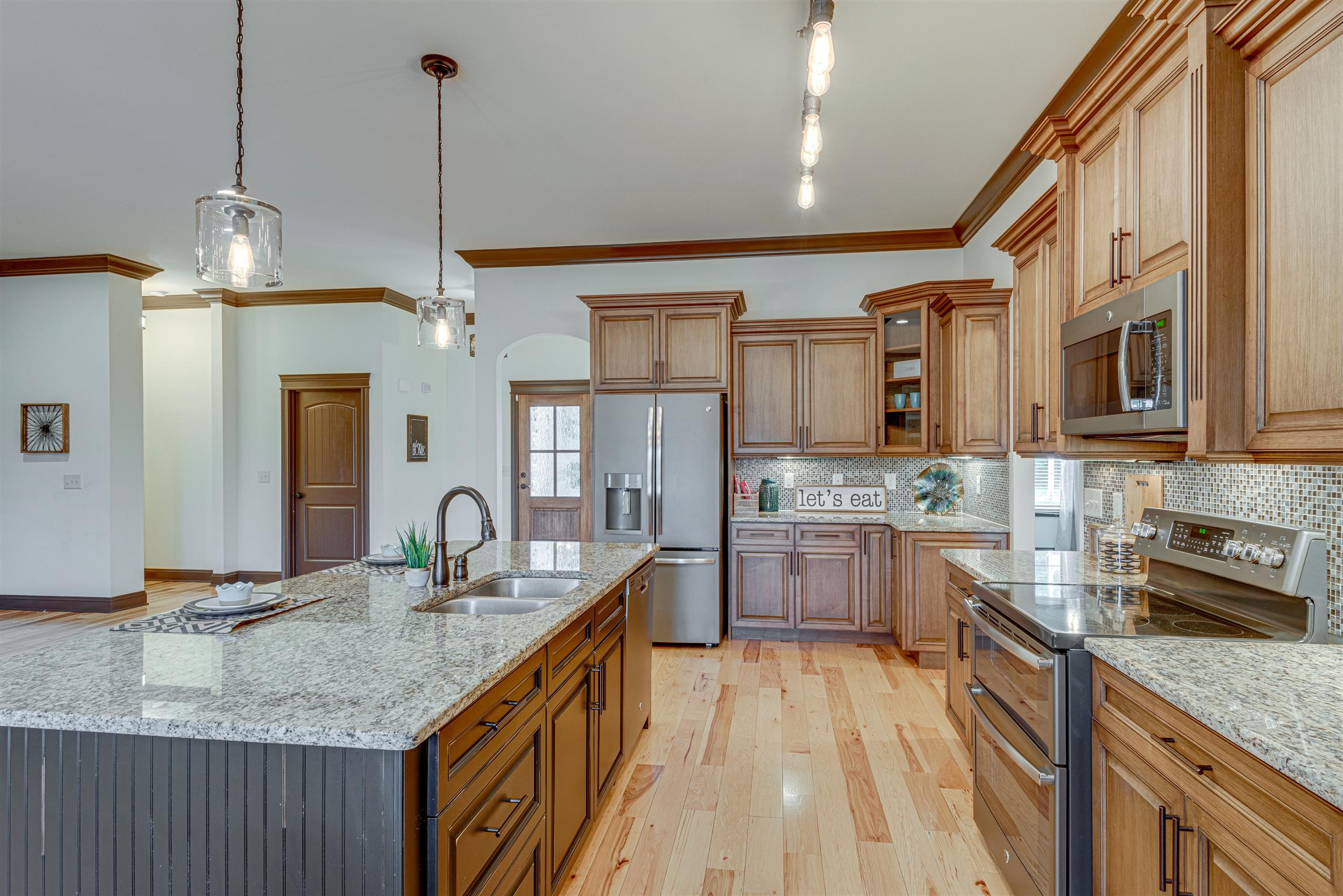 2610 Gunn Road Adams, TN 37010 - Photo 8 of 24 a kitchen with stainless steel appliances granite countertop a sink stove and refrigerator