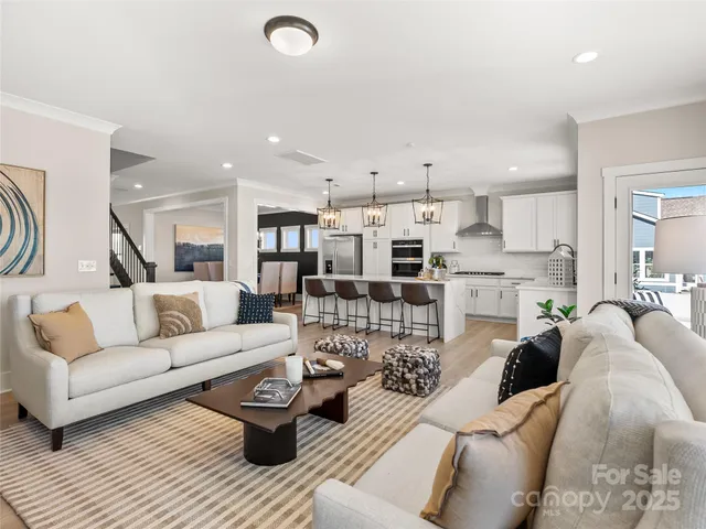 a living room with furniture and view of kitchen
