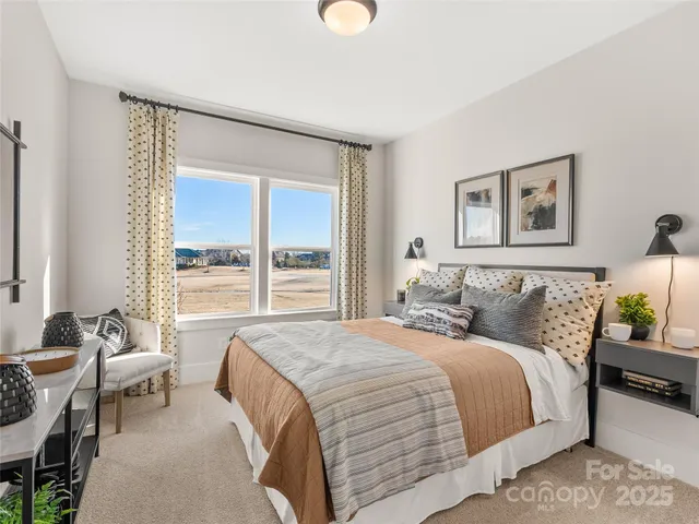a bedroom with a bed and a large window