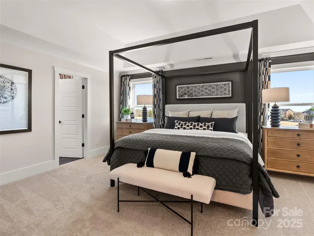 a bedroom with a bed a couch and dresser