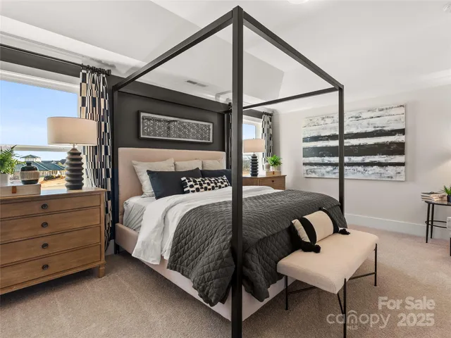 a bedroom with a bed a couch and a window