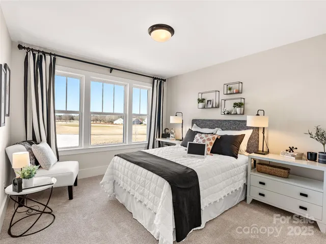 a large bedroom with a bed and a window