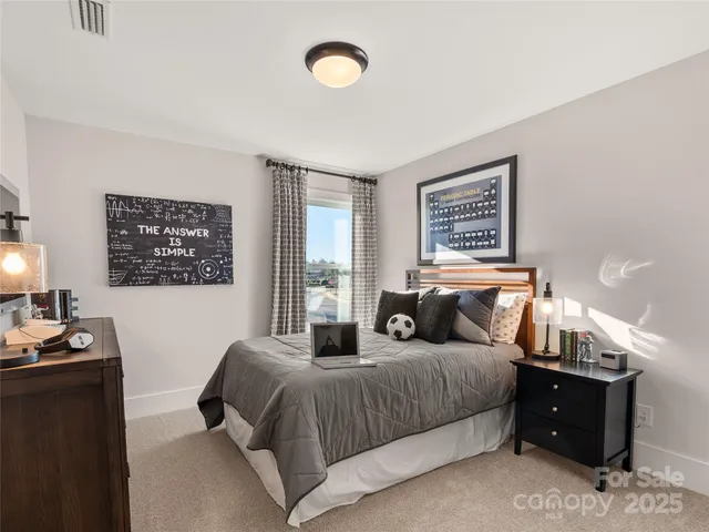 a bedroom with a bed and a night stand