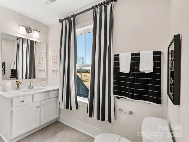 a bathroom with a double vanity sink a mirror a bathtub and shower