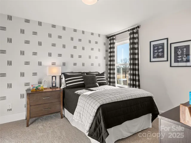 a bedroom with a bed and a night stand