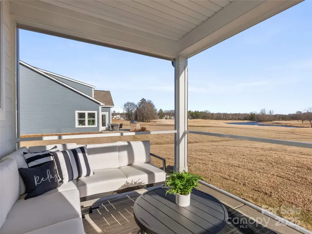 a view of a balcony with chair and wooden floor