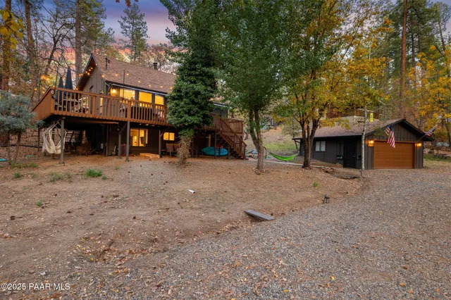 a view of a house with a yard and a tree
