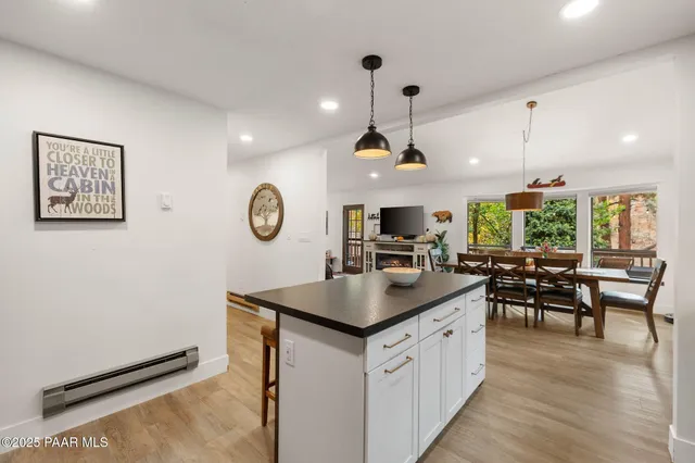 a dining room with furniture a chandelier and window