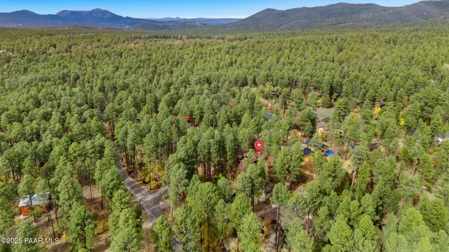 a view of a house with a deck and a yard