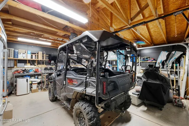 a view of a lush green field with a tree in the background