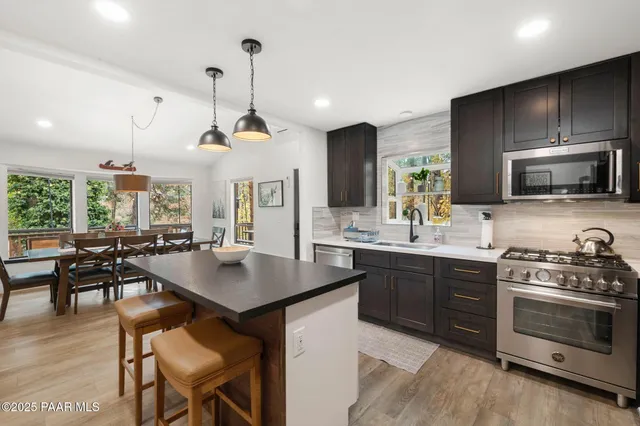 a kitchen with sink cabinets and stainless steel appliances