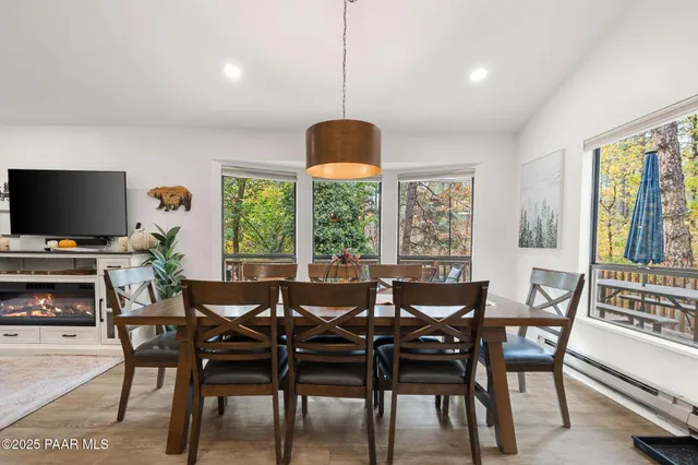 a view of a a dining room with furniture window and wooden floor