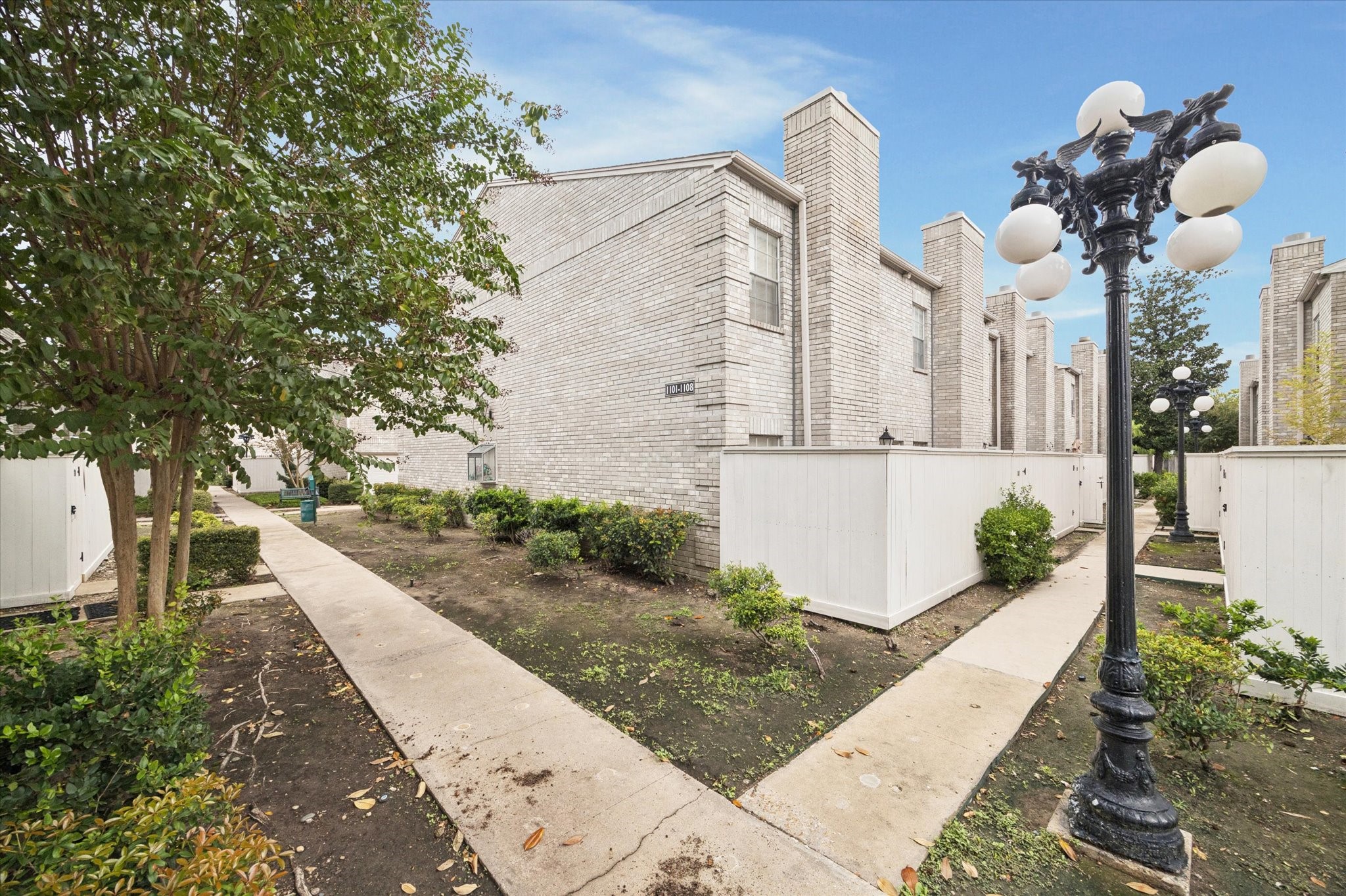 a view of a house with brick walls
