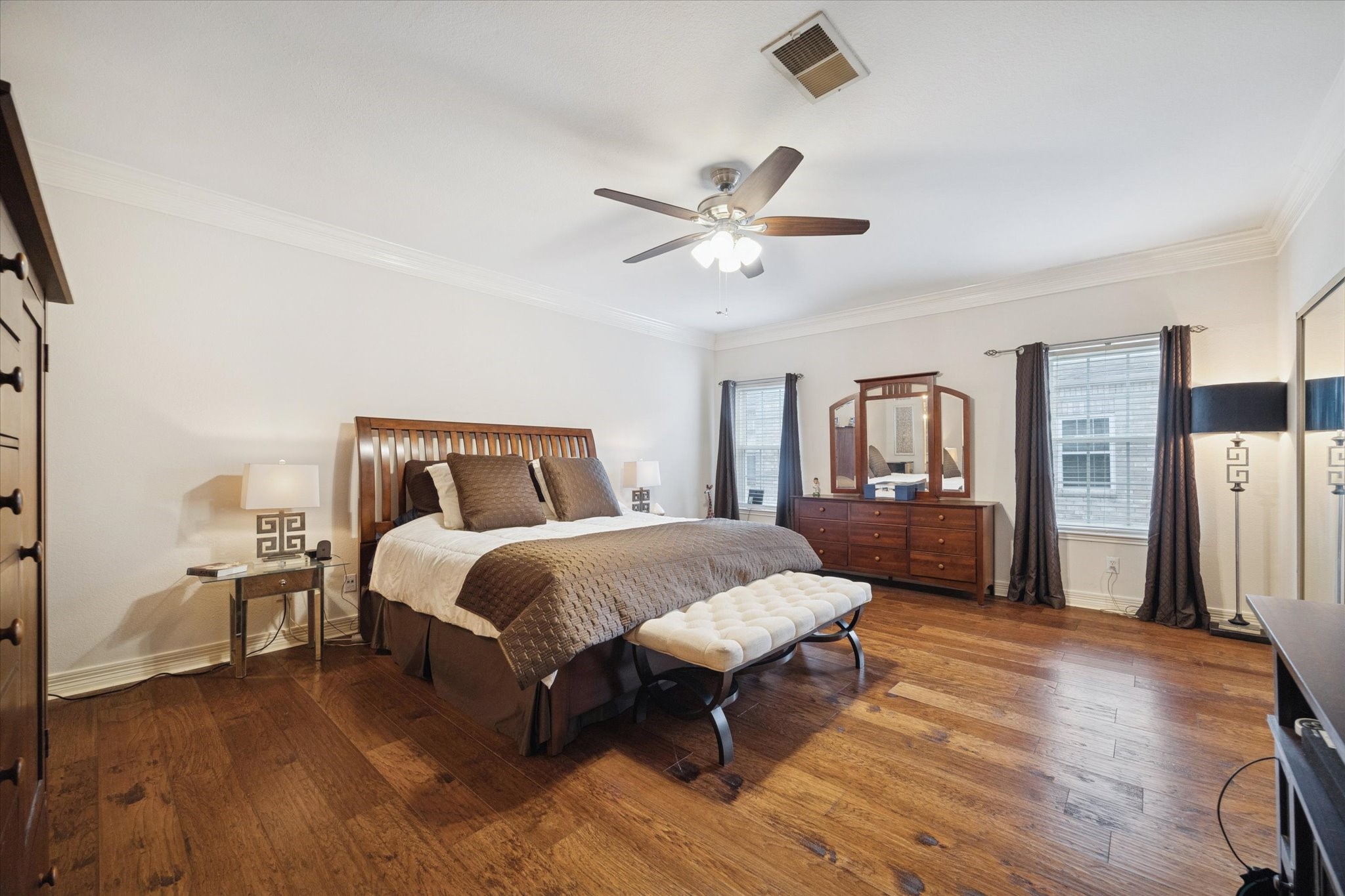 4001 Tanglewilde Street, Unit 1103 Houston, TX 77063 - Photo 12 of 15 a spacious bedroom with a bed and a chandelier