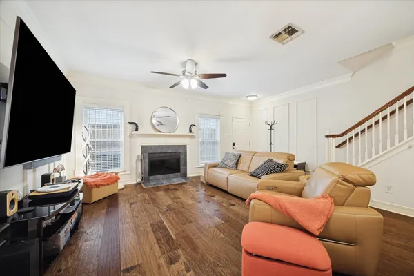 a living room with furniture and wooden floor