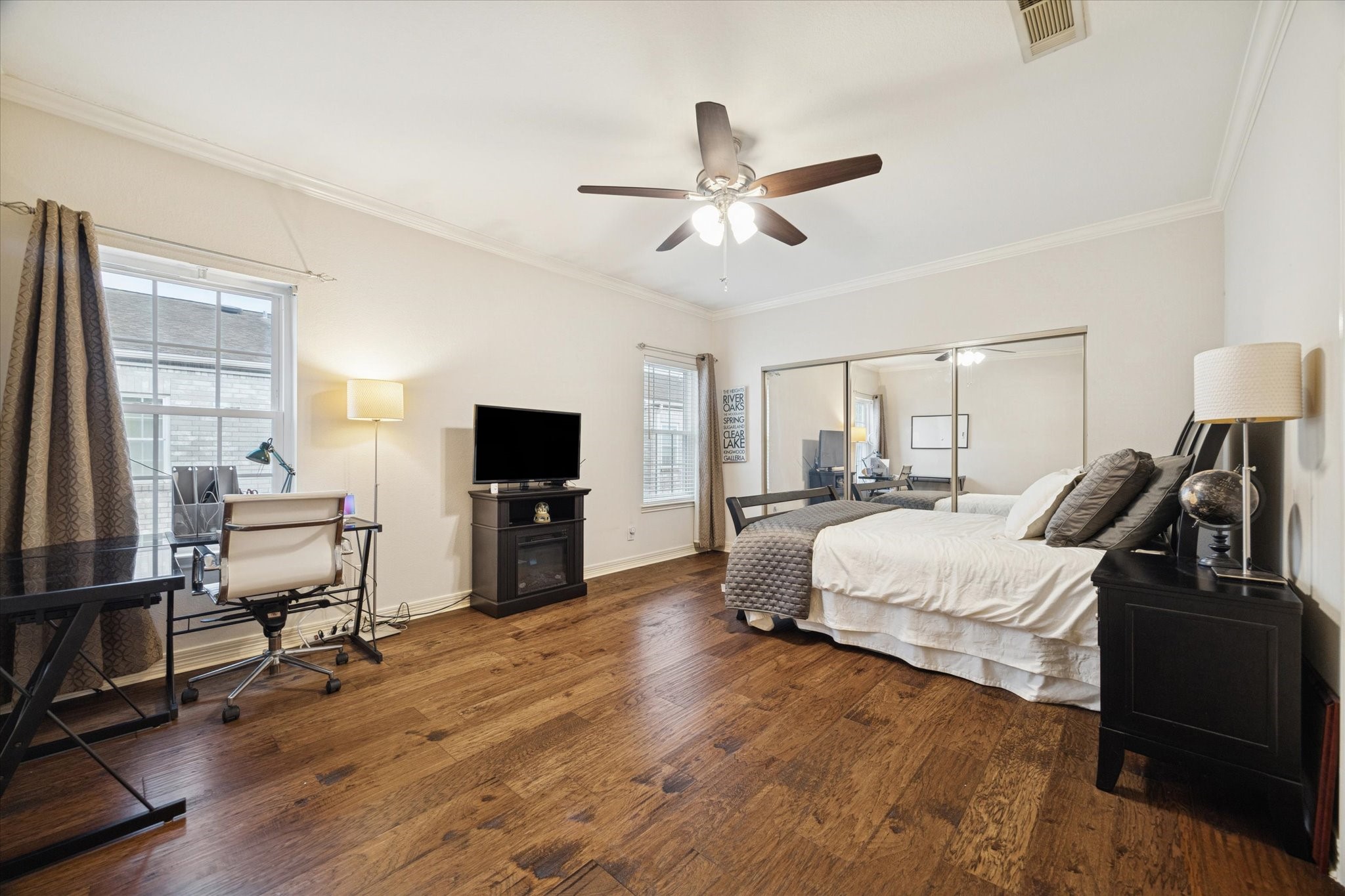 4001 Tanglewilde Street, Unit 1103 Houston, TX 77063 - Photo 10 of 15 a bedroom with a bed and wooden floor