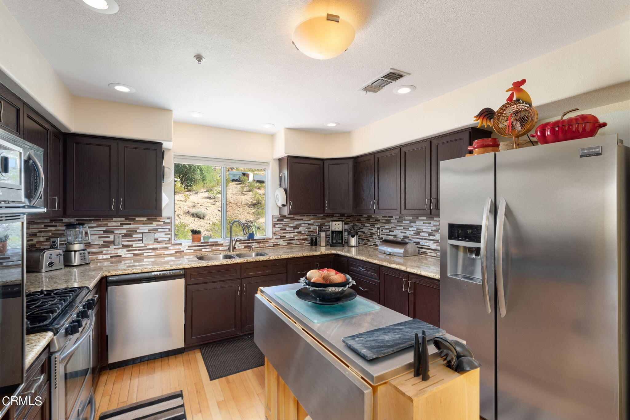 2249 Rim Road Palm Springs, CA 92264 - Photo 16 of 41 a kitchen with stainless steel appliances granite countertop a sink stove and refrigerator