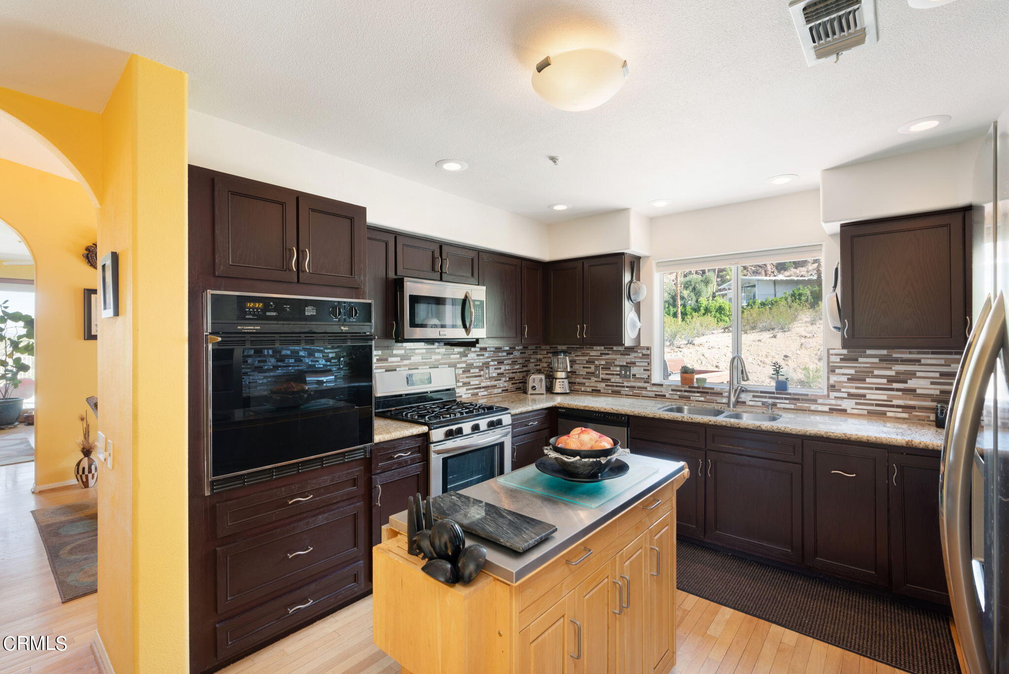 2249 Rim Road Palm Springs, CA 92264 - Photo 17 of 41 a kitchen with stainless steel appliances granite countertop a sink stove and refrigerator