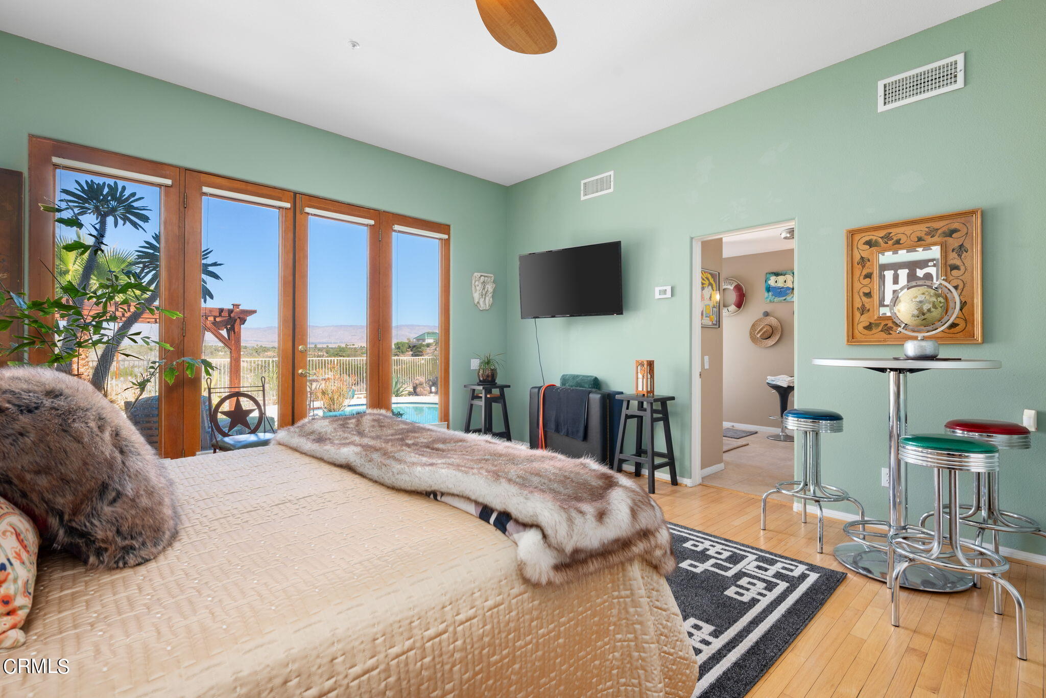 2249 Rim Road Palm Springs, CA 92264 - Photo 18 of 41 a bedroom with a bed a flat screen tv and a large window