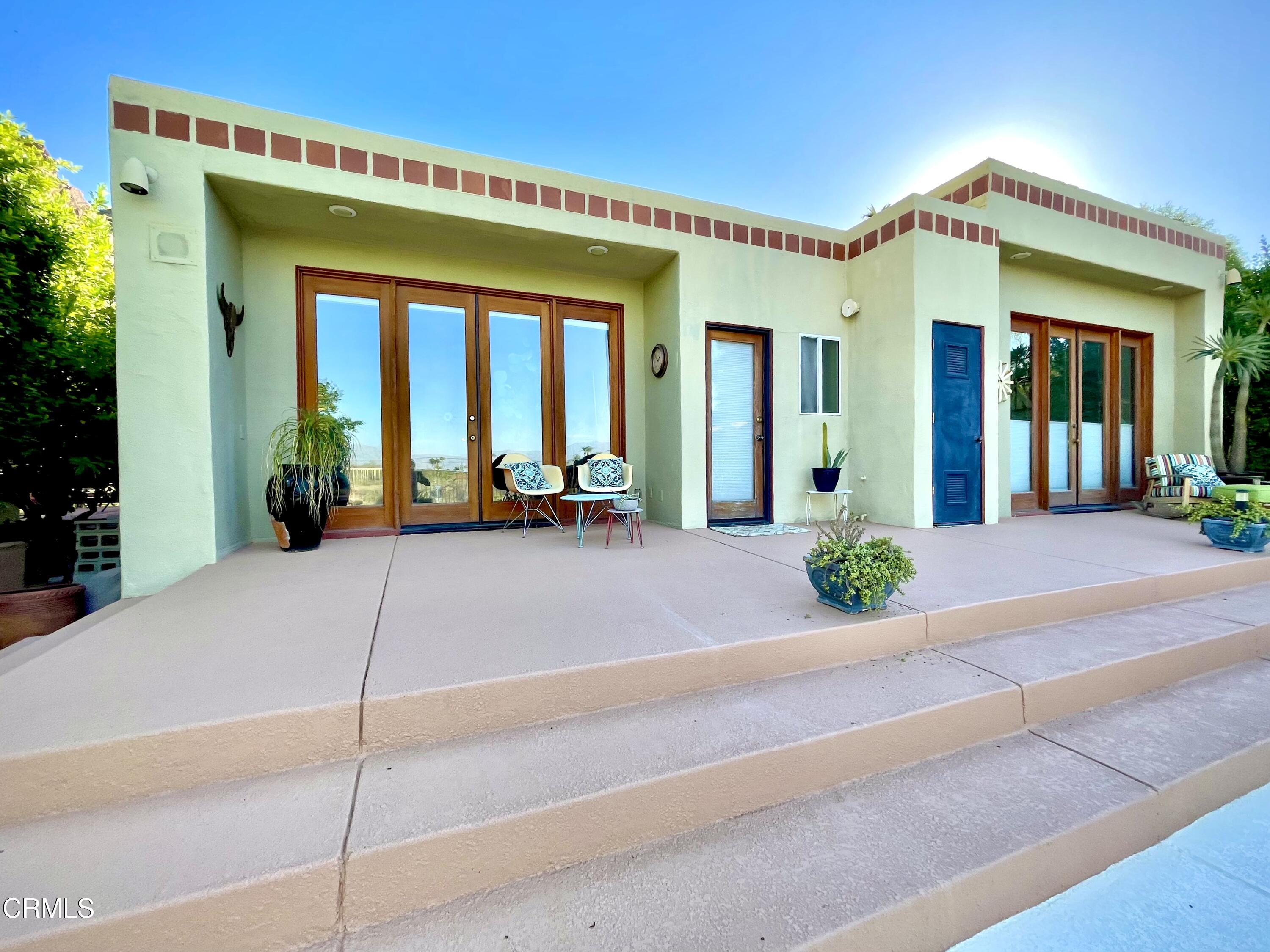 2249 Rim Road Palm Springs, CA 92264 - Photo 2 of 41 a view of a building with potted plants