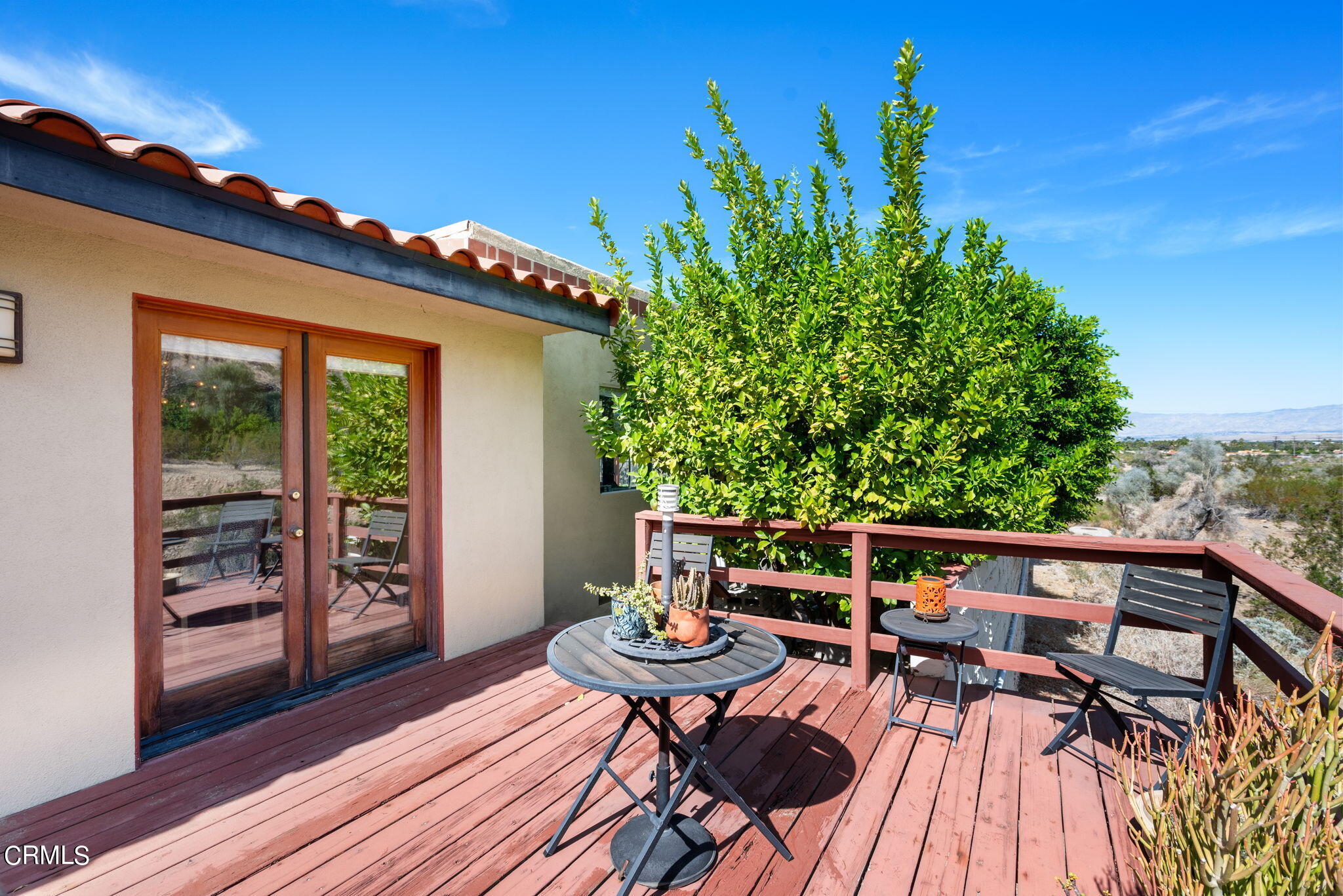 2249 Rim Road Palm Springs, CA 92264 - Photo 28 of 41 a balcony with wooden floor table and chairs
