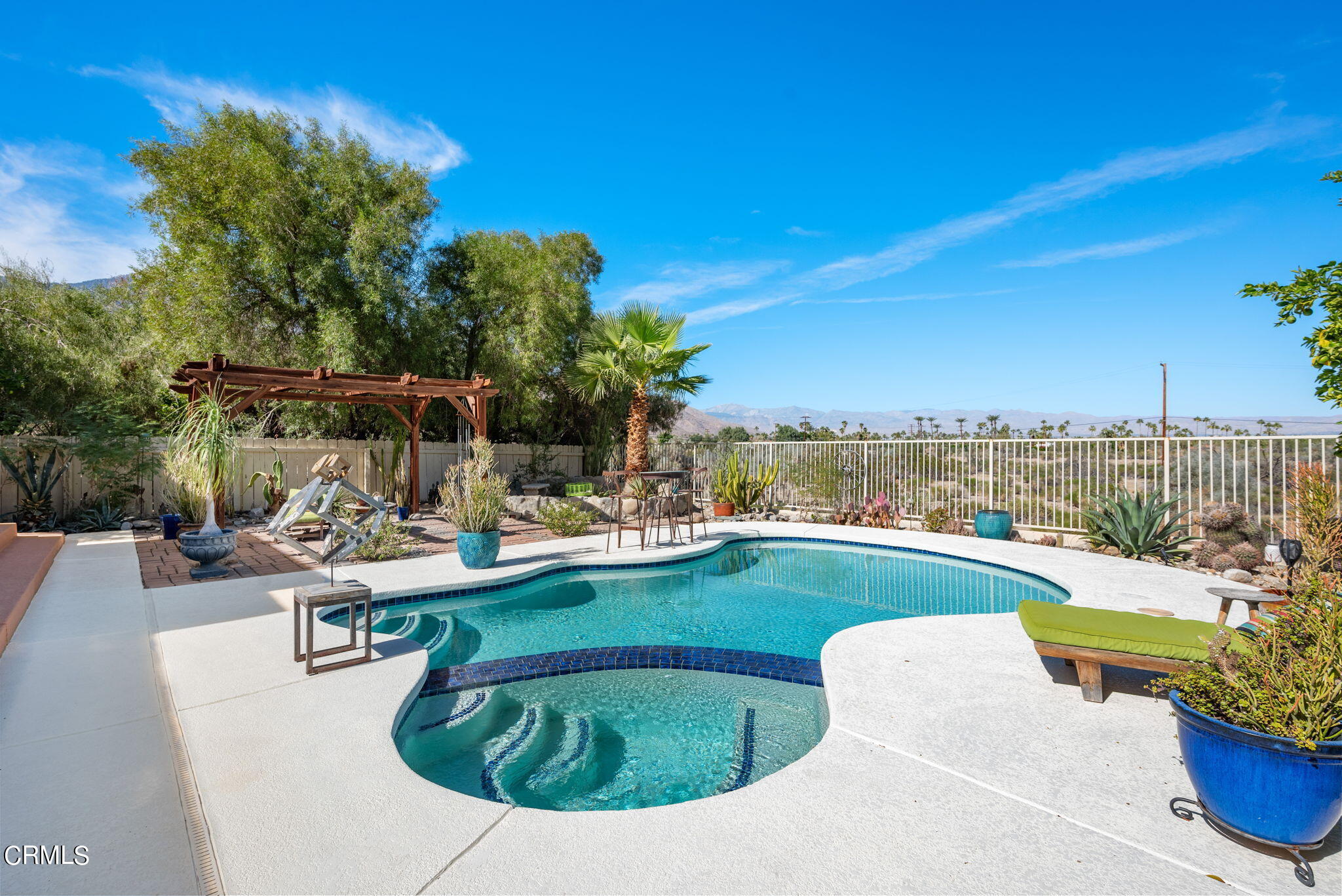 2249 Rim Road Palm Springs, CA 92264 - Photo 3 of 41 a view of a swimming pool with lounge chairs