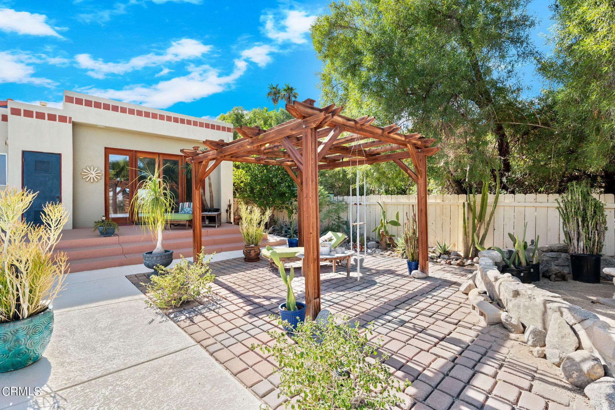2249 Rim Road Palm Springs, CA 92264 - Photo 38 of 41 a patio with a table and chairs and potted plants