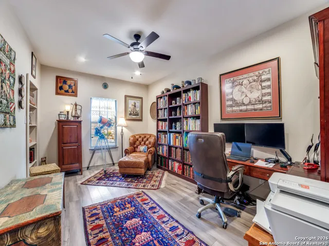a view of a workspace with furniture and a window
