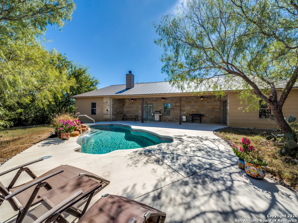 6472 Bluntzer Road Jourdanton, TX 78026 - Photo 19 of 45 a front view of a house with a yard and garage