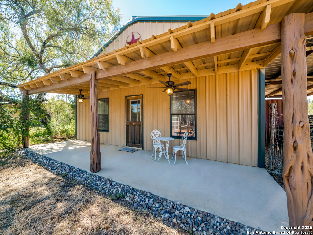 6472 Bluntzer Road Jourdanton, TX 78026 - Photo 22 of 45 a view of a chairs and table in front of a house
