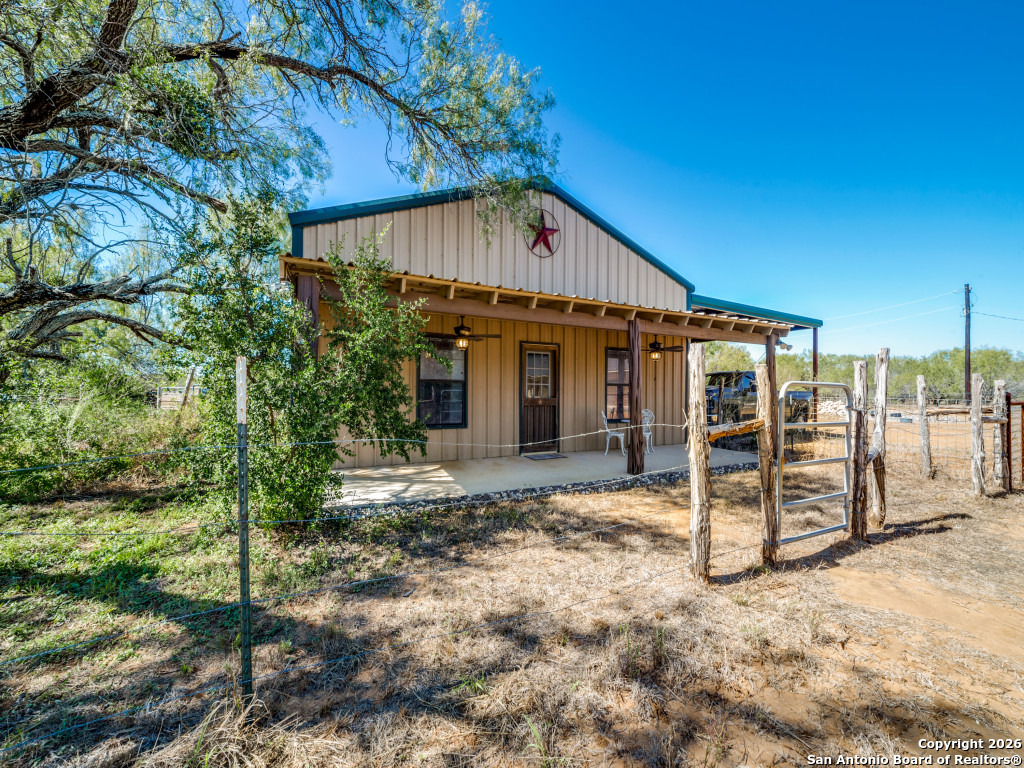 6472 Bluntzer Road Jourdanton, TX 78026 - Photo 23 of 45 a view of a house with a yard