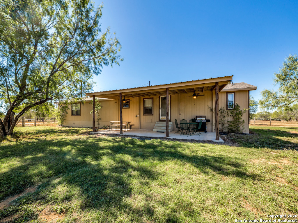 6472 Bluntzer Road Jourdanton, TX 78026 - Photo 29 of 45 a view of a house with backyard and sitting area