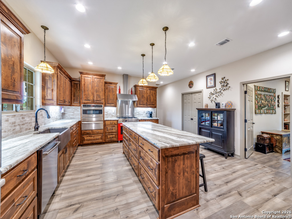 6472 Bluntzer Road Jourdanton, TX 78026 - Photo 6 of 45 a large kitchen with stainless steel appliances lots of counter space
