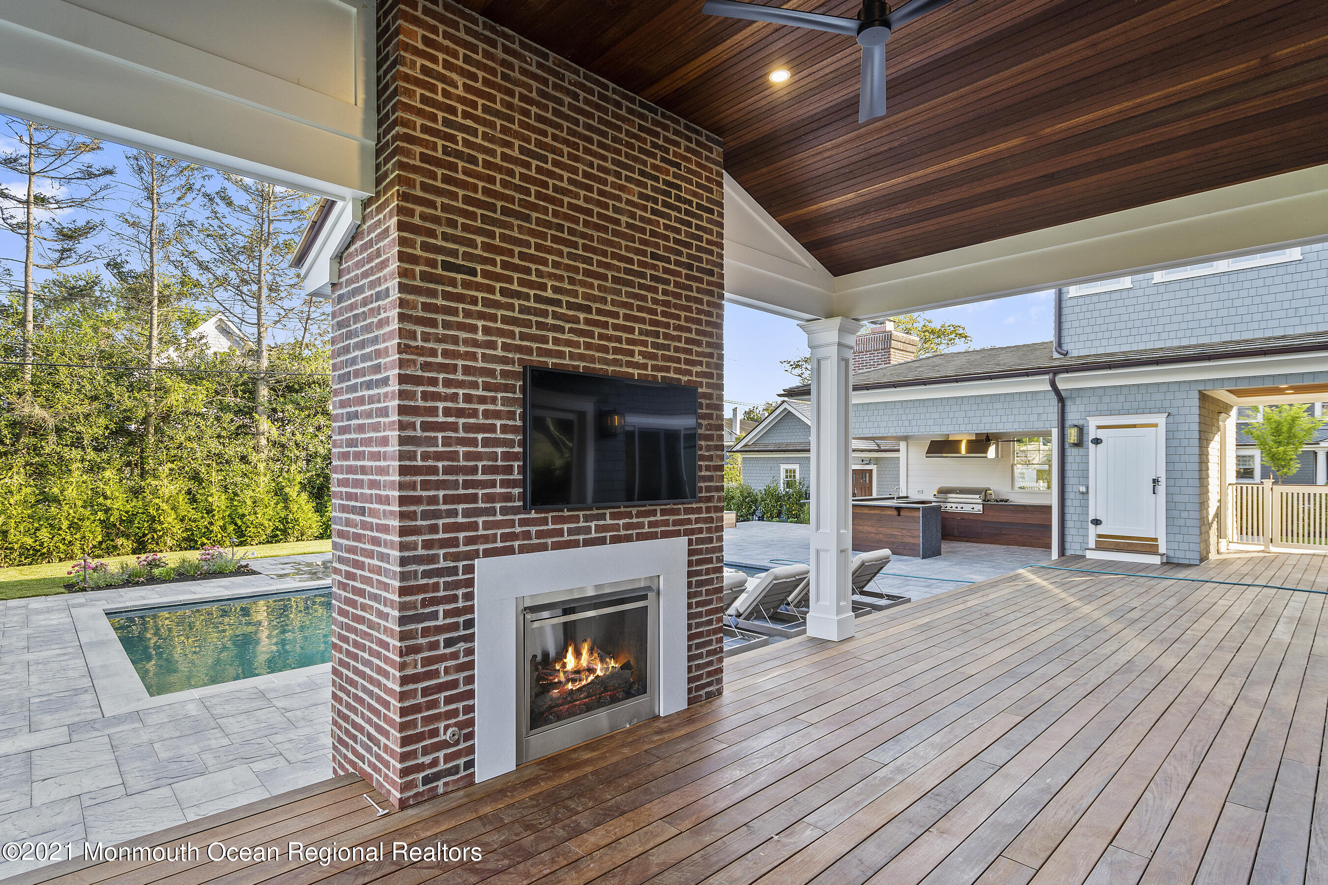 101 Ludlow Avenue Spring Lake, NJ 07762 - Photo 122 of 162 a living room with furniture a fireplace and a flat screen tv