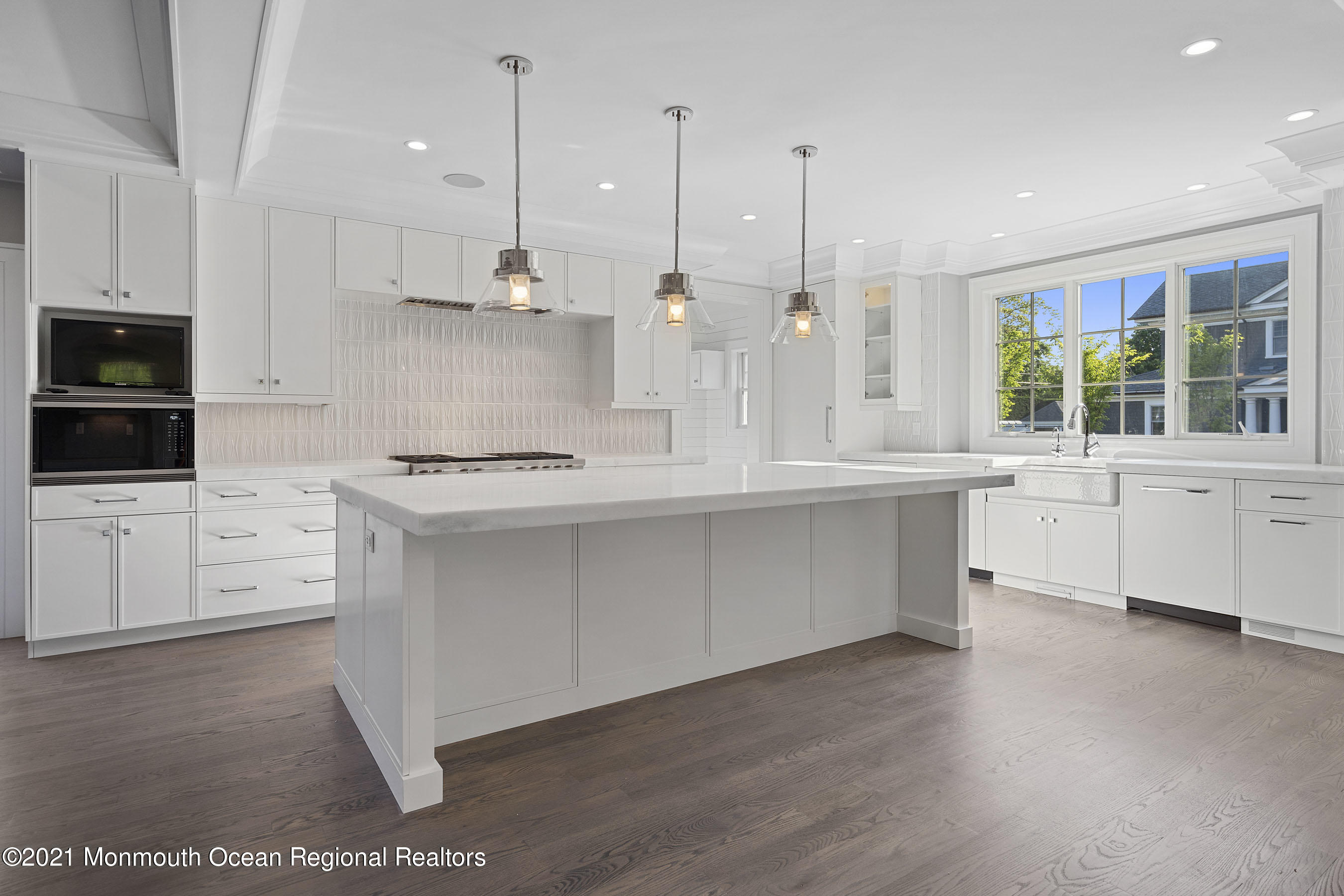 101 Ludlow Avenue Spring Lake, NJ 07762 - Photo 26 of 162 a kitchen with stainless steel appliances kitchen island granite countertop a stove a sink and white cabinets with wooden floor