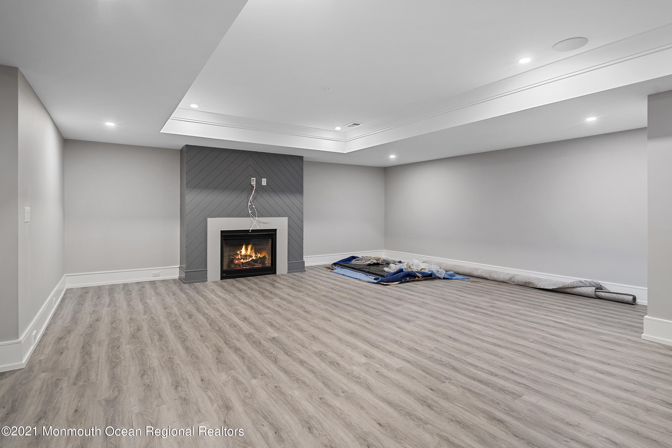 101 Ludlow Avenue Spring Lake, NJ 07762 - Photo 70 of 162 an empty room with wooden floor and a fireplace