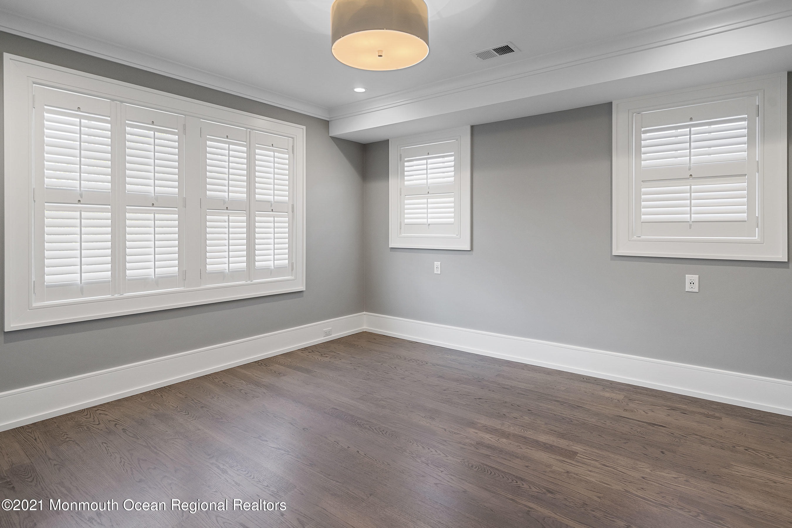 101 Ludlow Avenue Spring Lake, NJ 07762 - Photo 79 of 162 an empty room with wooden floor and windows