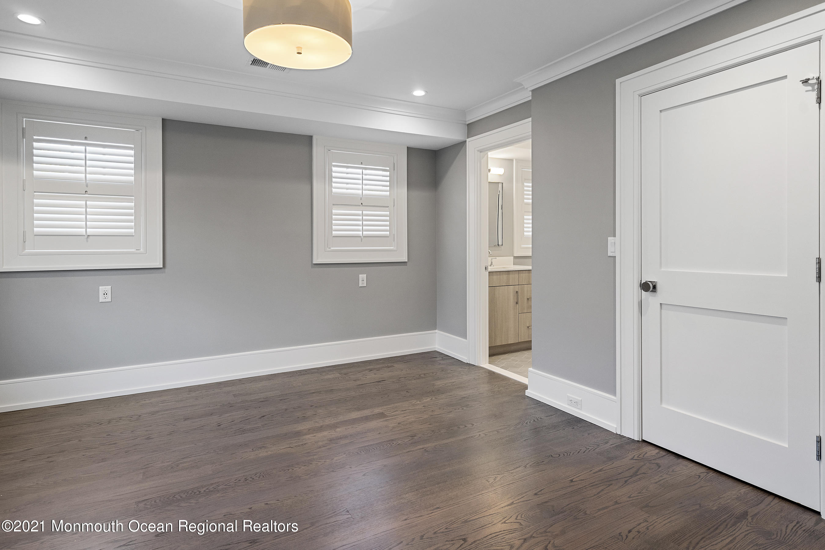 101 Ludlow Avenue Spring Lake, NJ 07762 - Photo 80 of 162 an empty room with wooden floor and windows