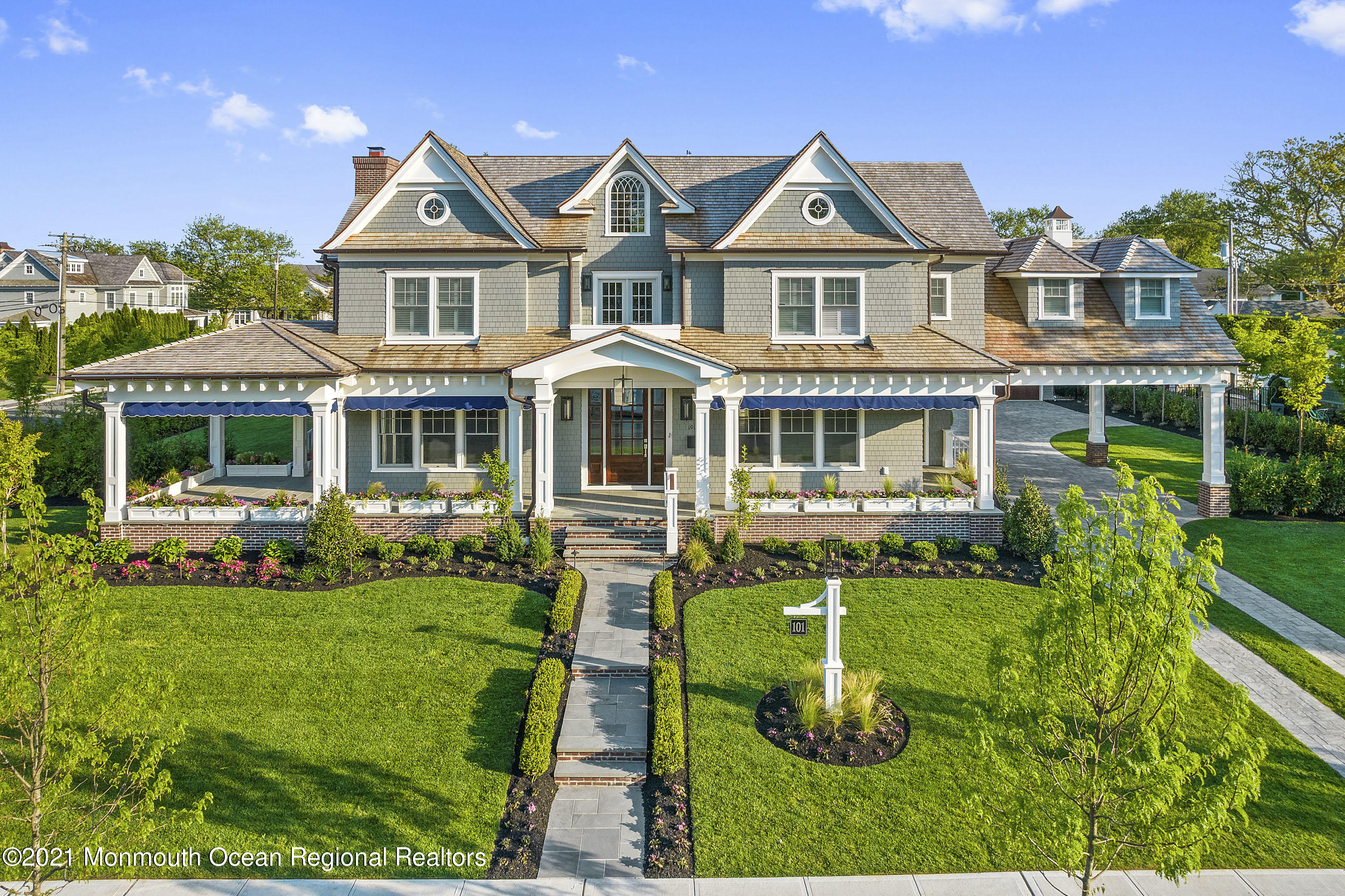 101 Ludlow Avenue Spring Lake, NJ 07762 - Photo 9 of 162 a front view of a house with a yard table and chairs