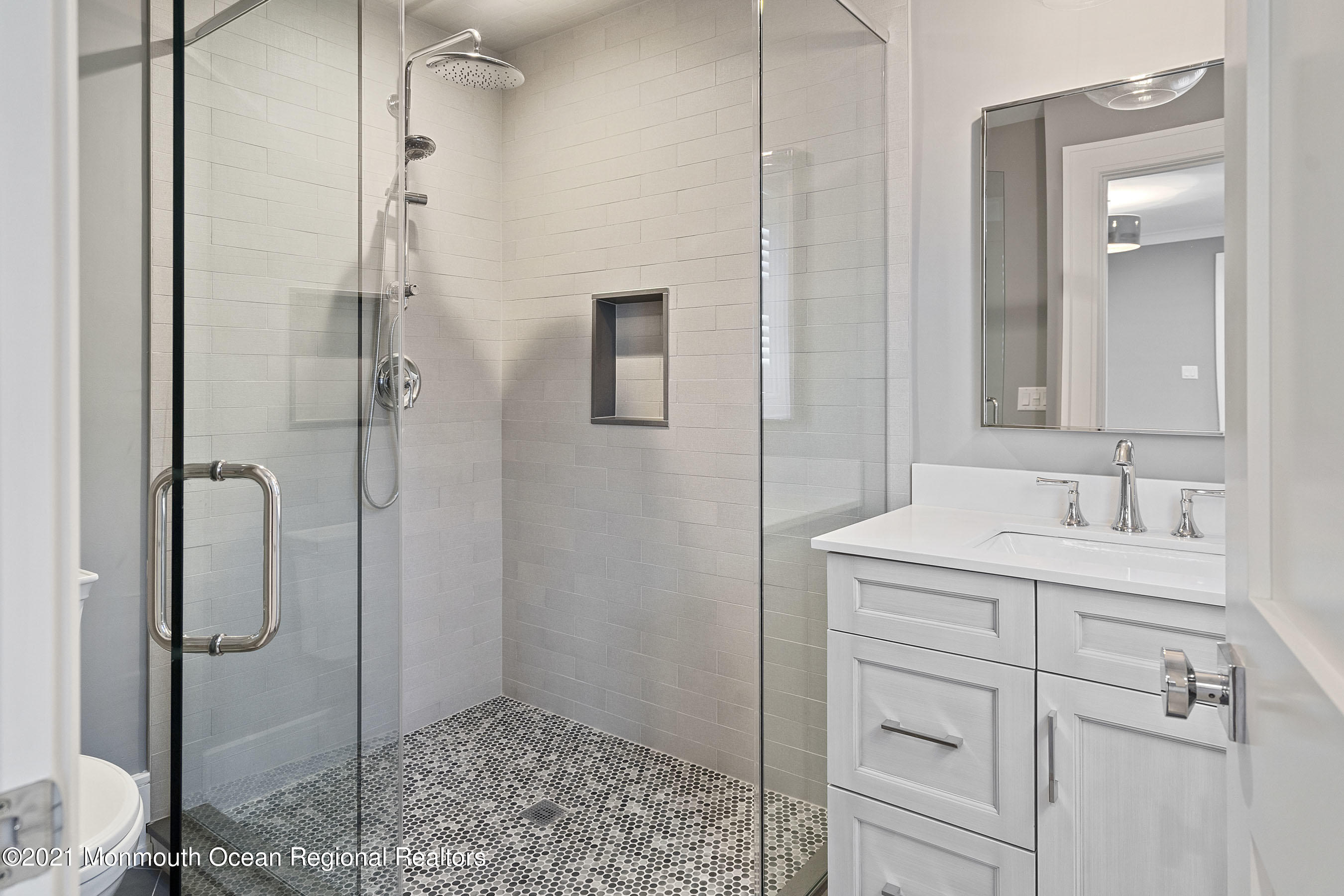 101 Ludlow Avenue Spring Lake, NJ 07762 - Photo 85 of 162 a bathroom with a shower sink and mirror