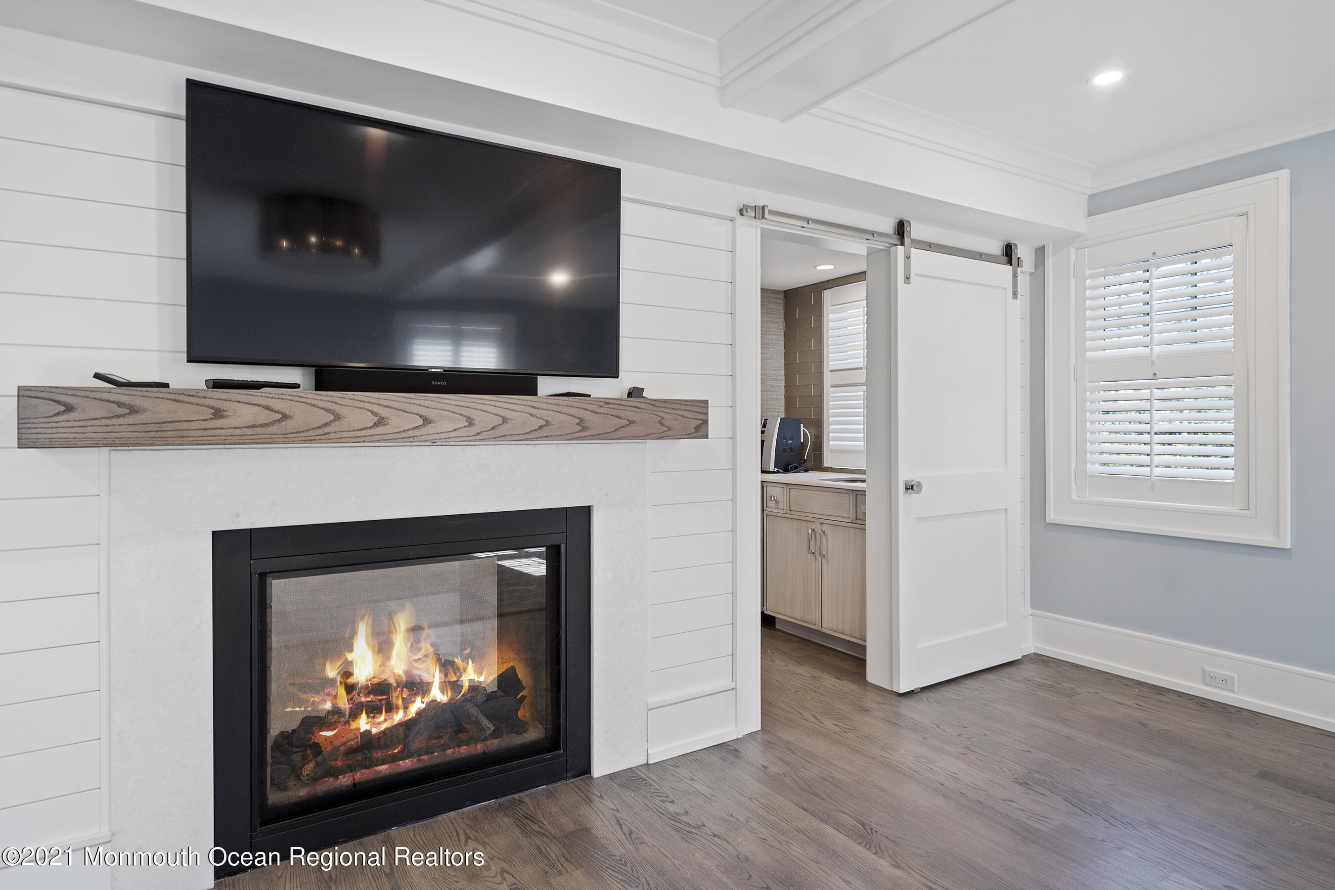 101 Ludlow Avenue Spring Lake, NJ 07762 - Photo 99 of 162 a living room with a fireplace and a flat screen tv