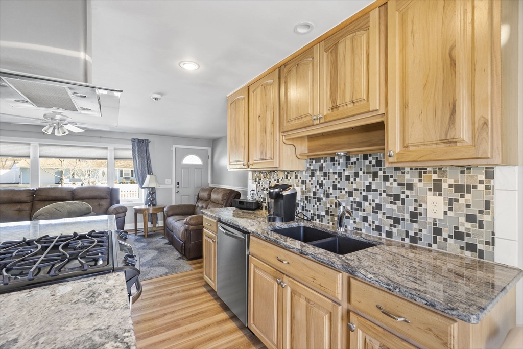 134 Deanna Road Brockton, MA 02302 - Photo 6 of 33 a kitchen with stainless steel appliances kitchen island granite countertop a sink stove and cabinets