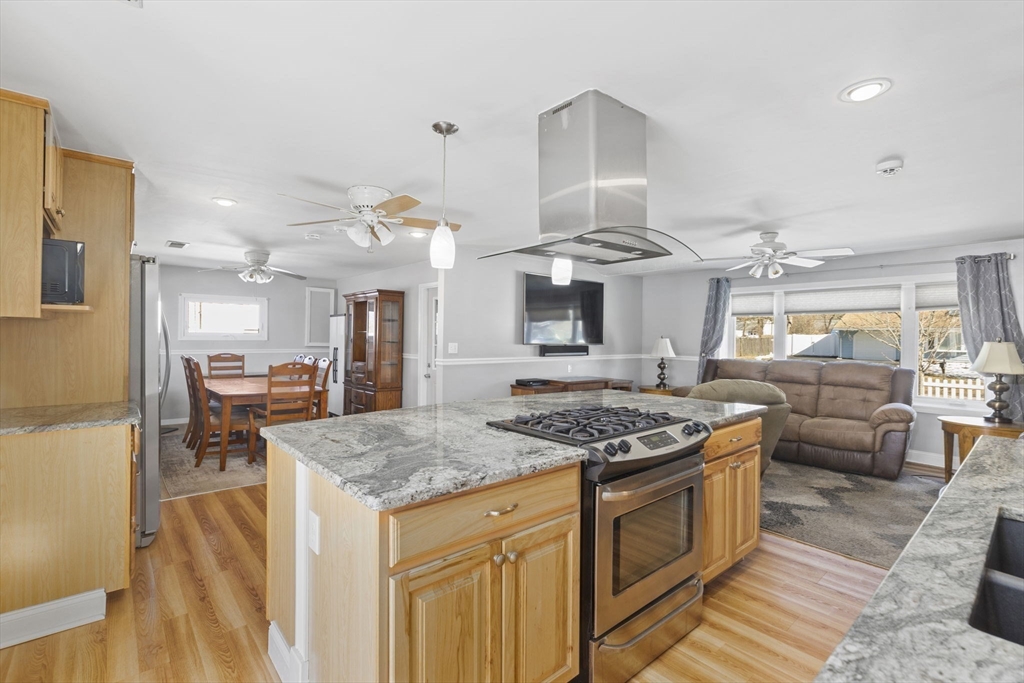 134 Deanna Road Brockton, MA 02302 - Photo 7 of 33 a kitchen with stainless steel appliances granite countertop a stove and a view of living room
