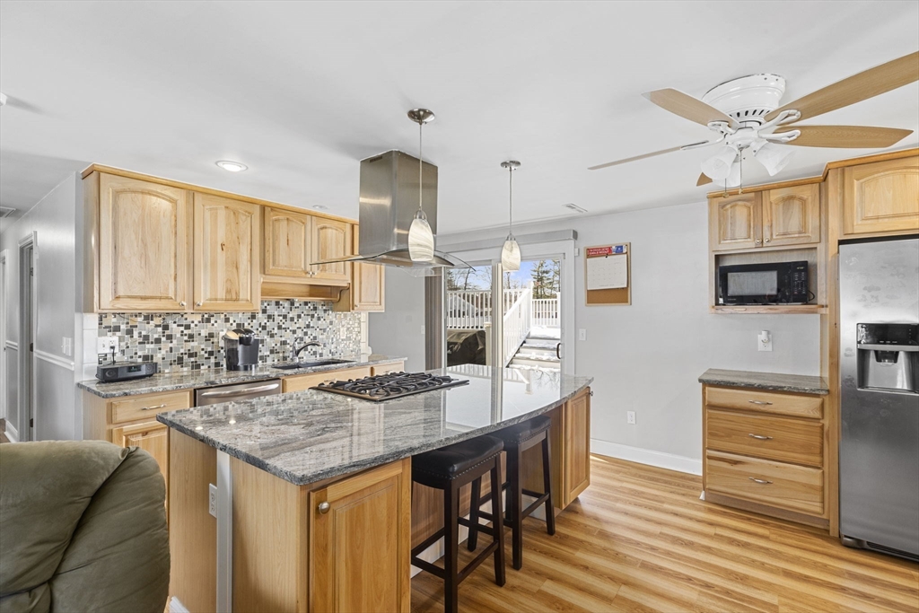 134 Deanna Road Brockton, MA 02302 - Photo 8 of 33 a kitchen with granite countertop a table chairs stove and refrigerator